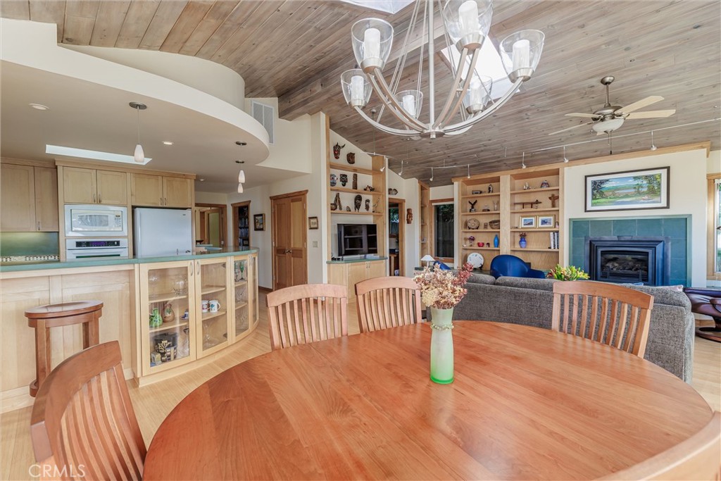 10 11th Street Cayucos, CA 93430 - Photo 32 of 33 a view of a livingroom with furniture a fireplace wooden floor and chandelier