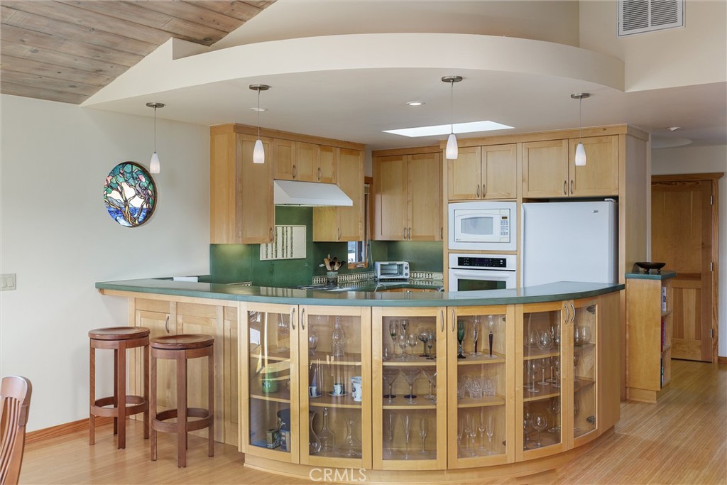 10 11th Street Cayucos, CA 93430 - Photo 11 of 33 a view of a kitchen with dining table and chairs