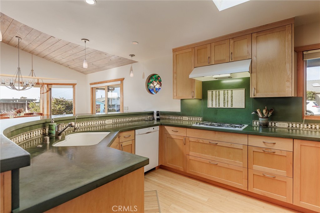 10 11th Street Cayucos, CA 93430 - Photo 12 of 33 a kitchen with granite countertop a sink and white cabinets