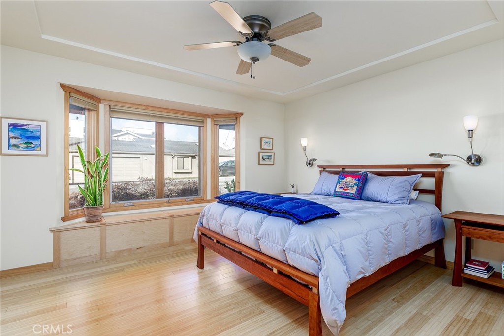 10 11th Street Cayucos, CA 93430 - Photo 14 of 33 a bedroom with a bed and a large window with wooden floor