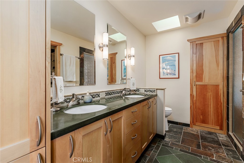 10 11th Street Cayucos, CA 93430 - Photo 15 of 33 a bathroom with a double vanity sink toilet and shower