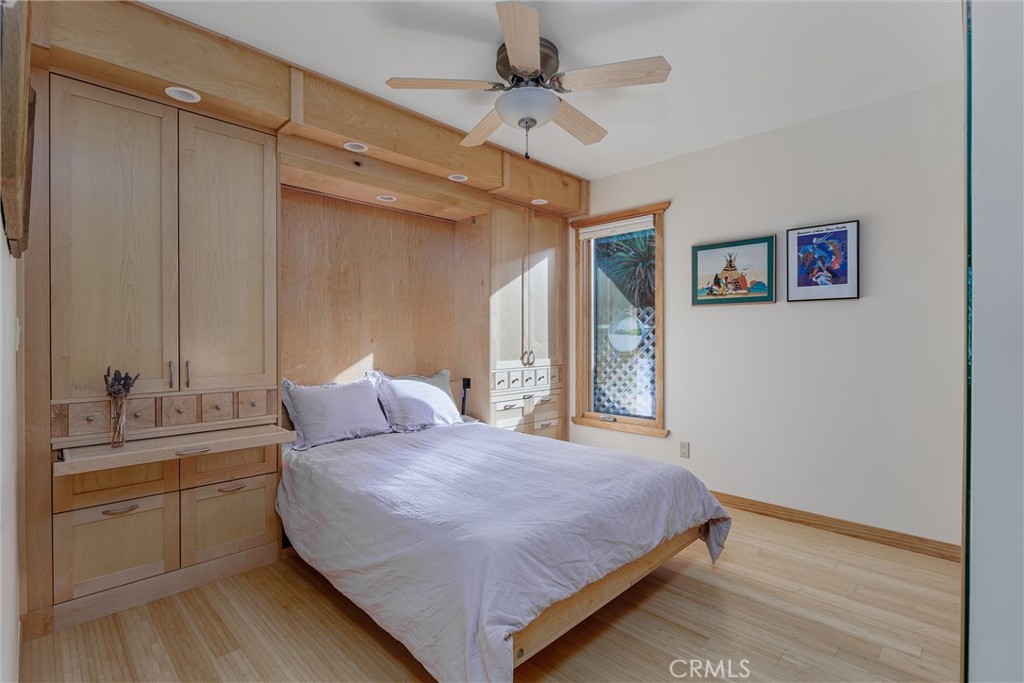 10 11th Street Cayucos, CA 93430 - Photo 17 of 33 a bedroom with a large bed and a chandelier