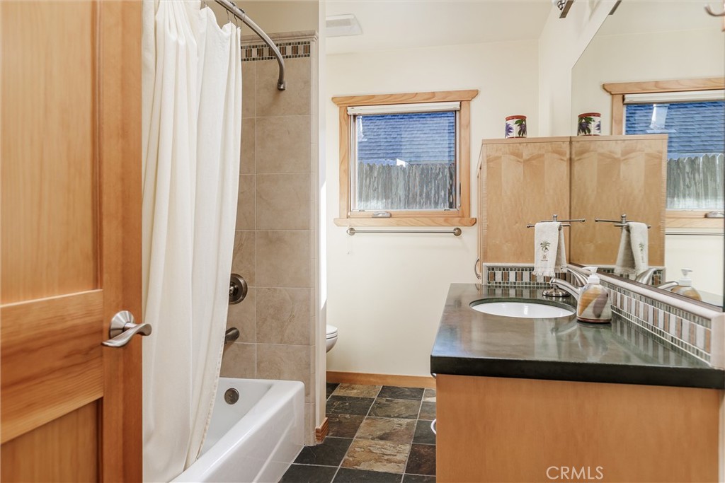 10 11th Street Cayucos, CA 93430 - Photo 20 of 33 a bathroom with a sink and a mirror