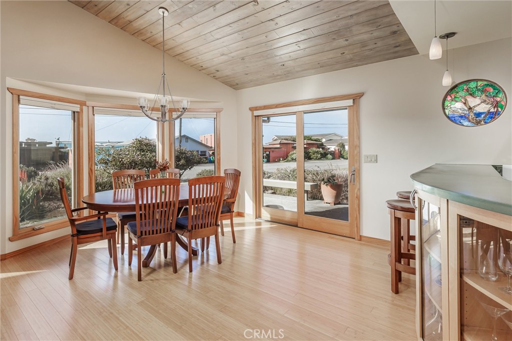 10 11th Street Cayucos, CA 93430 - Photo 10 of 33 a dining room with furniture water view and a floor to ceiling window