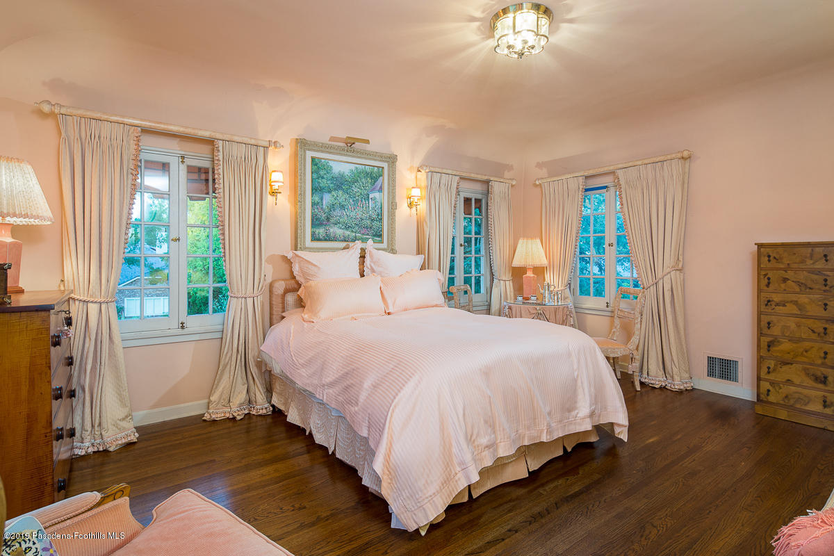 104 Club Road Pasadena, CA 91105 - Photo 31 of 43 a bedroom with a bed and a chandelier