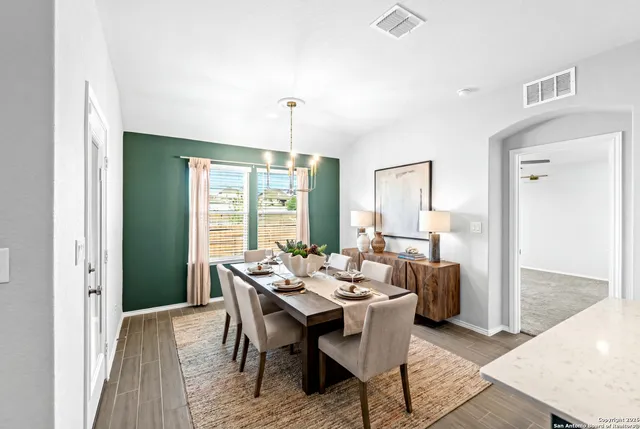 a view of a dining room with furniture window and wooden floor