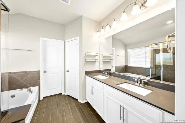 a open kitchen with a sink and wooden floor
