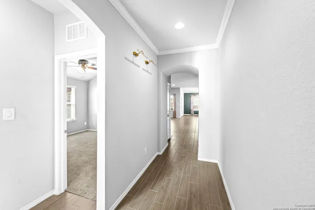 a view of a hallway with wooden floor