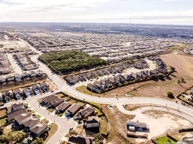 an aerial view of residential houses with outdoor space