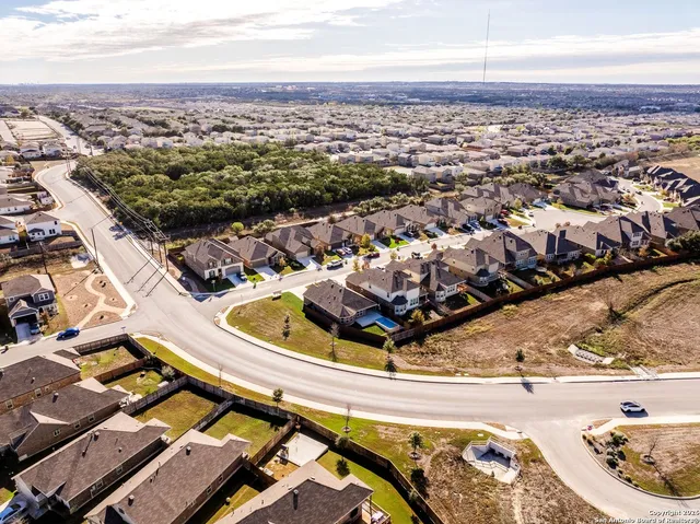 an aerial view of residential houses with outdoor space