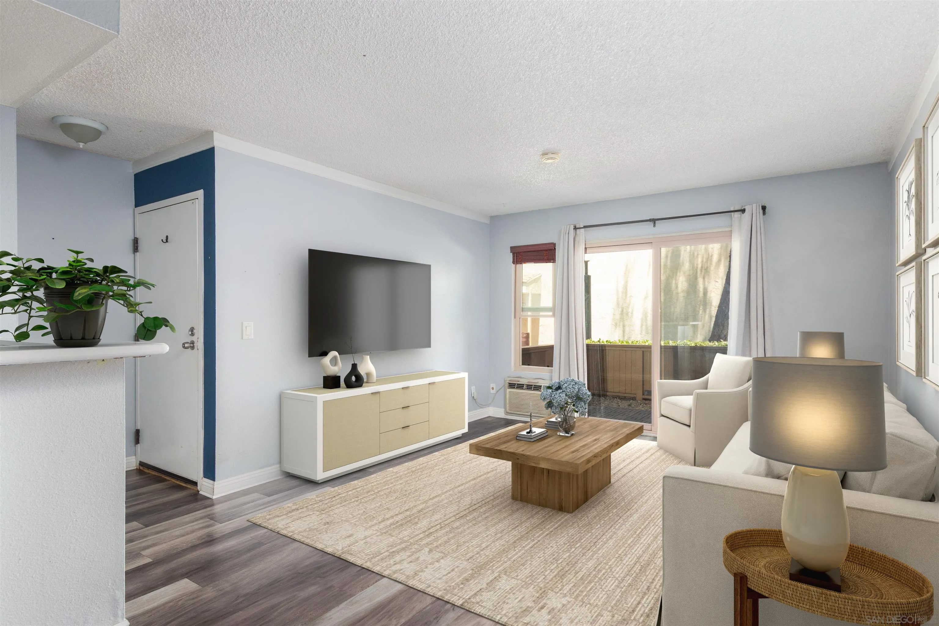 5922 Rancho Mission Road, Unit 67 San Diego, CA 92108 - Photo 1 of 19 a living room with furniture and a flat screen tv