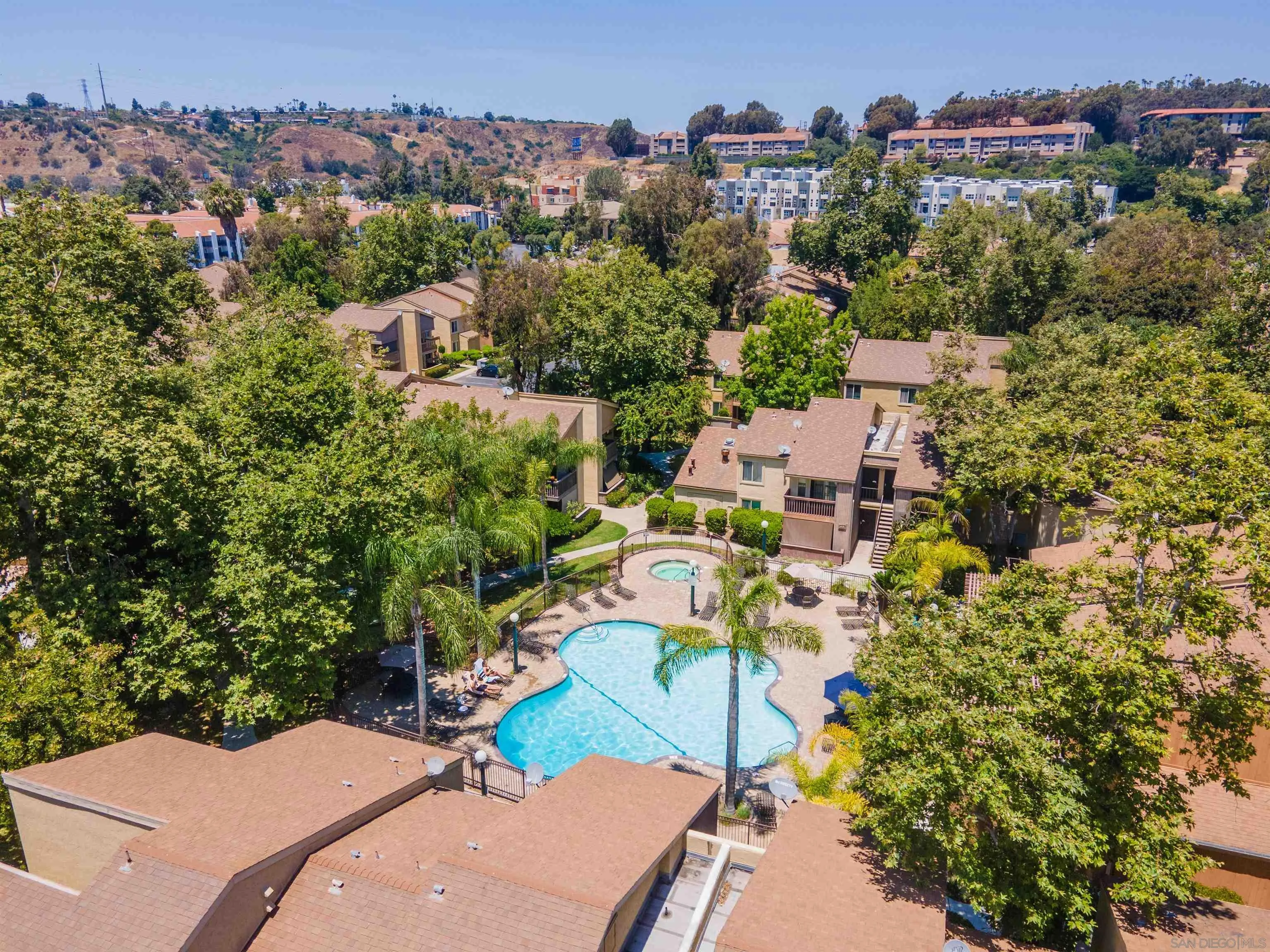 5922 Rancho Mission Road, Unit 67 San Diego, CA 92108 - Photo 14 of 19 an aerial view of a house with a yard and lake view in back