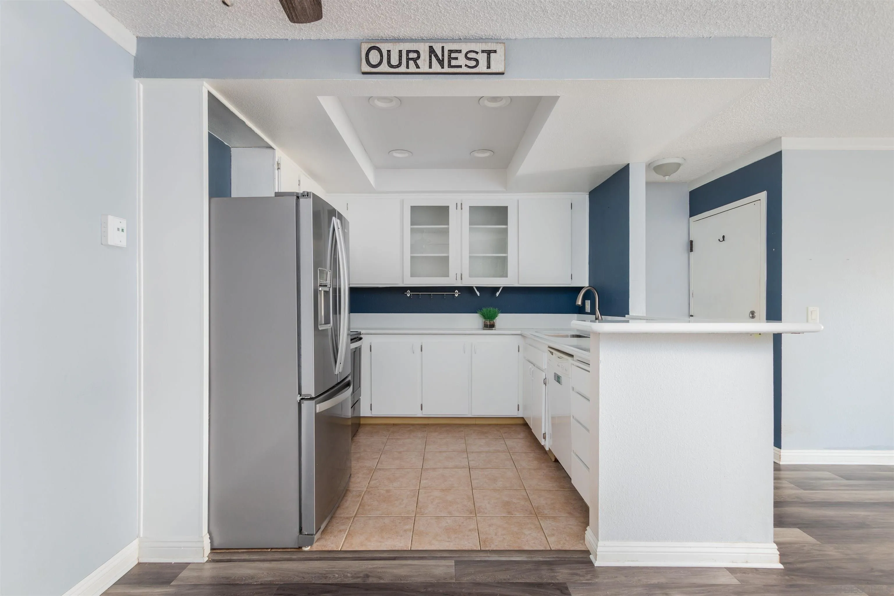 5922 Rancho Mission Road, Unit 67 San Diego, CA 92108 - Photo 5 of 19 a kitchen with granite countertop white cabinets and stainless steel appliances