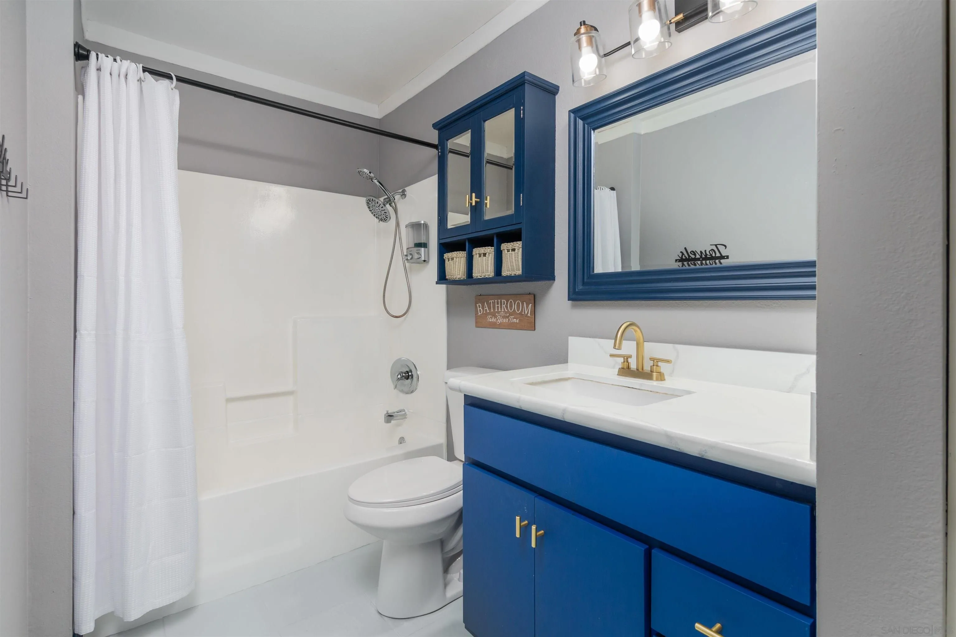5922 Rancho Mission Road, Unit 67 San Diego, CA 92108 - Photo 8 of 19 a bathroom with a granite countertop sink toilet a mirror and shower