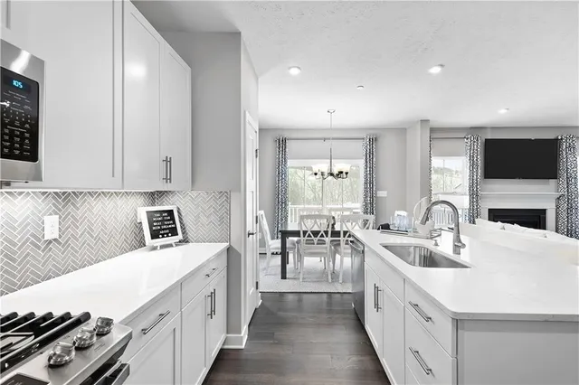 a kitchen with sink stove top oven and refrigerator
