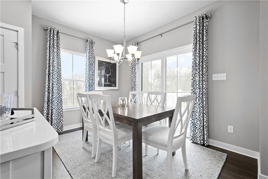 130 Olivia Drive Eighty Four, PA 15330 - Photo 9 of 27 a dining room with furniture a chandelier and wooden floor