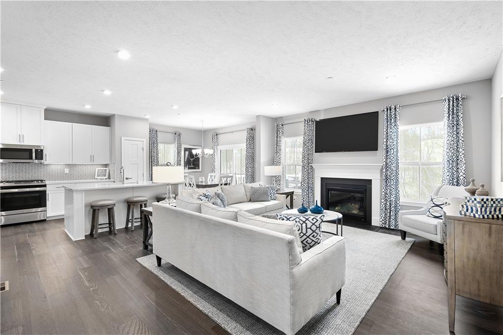 130 Olivia Drive Eighty Four, PA 15330 - Photo 10 of 27 a living room with furniture a fireplace and a flat screen tv