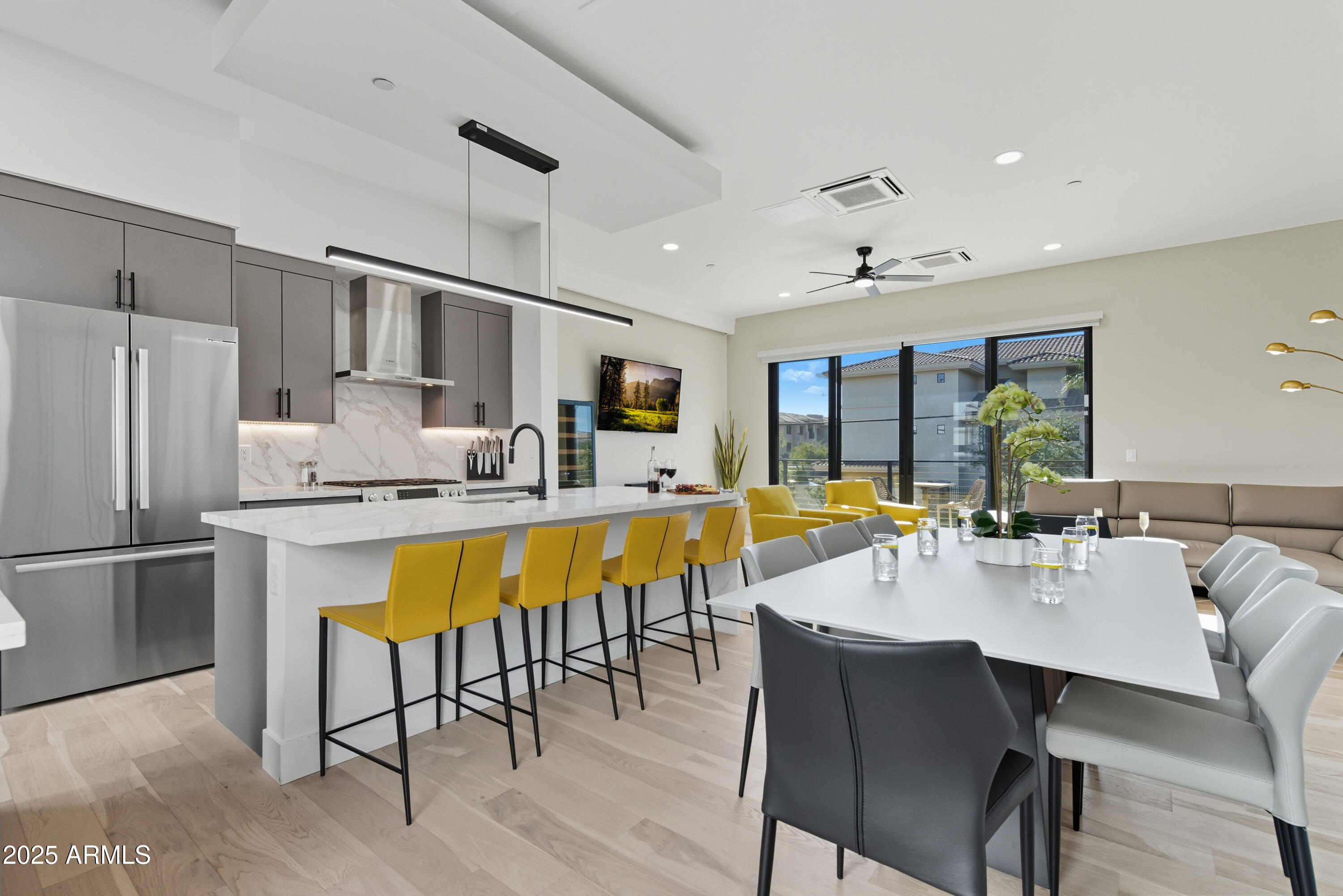 a large kitchen with a table and chairs