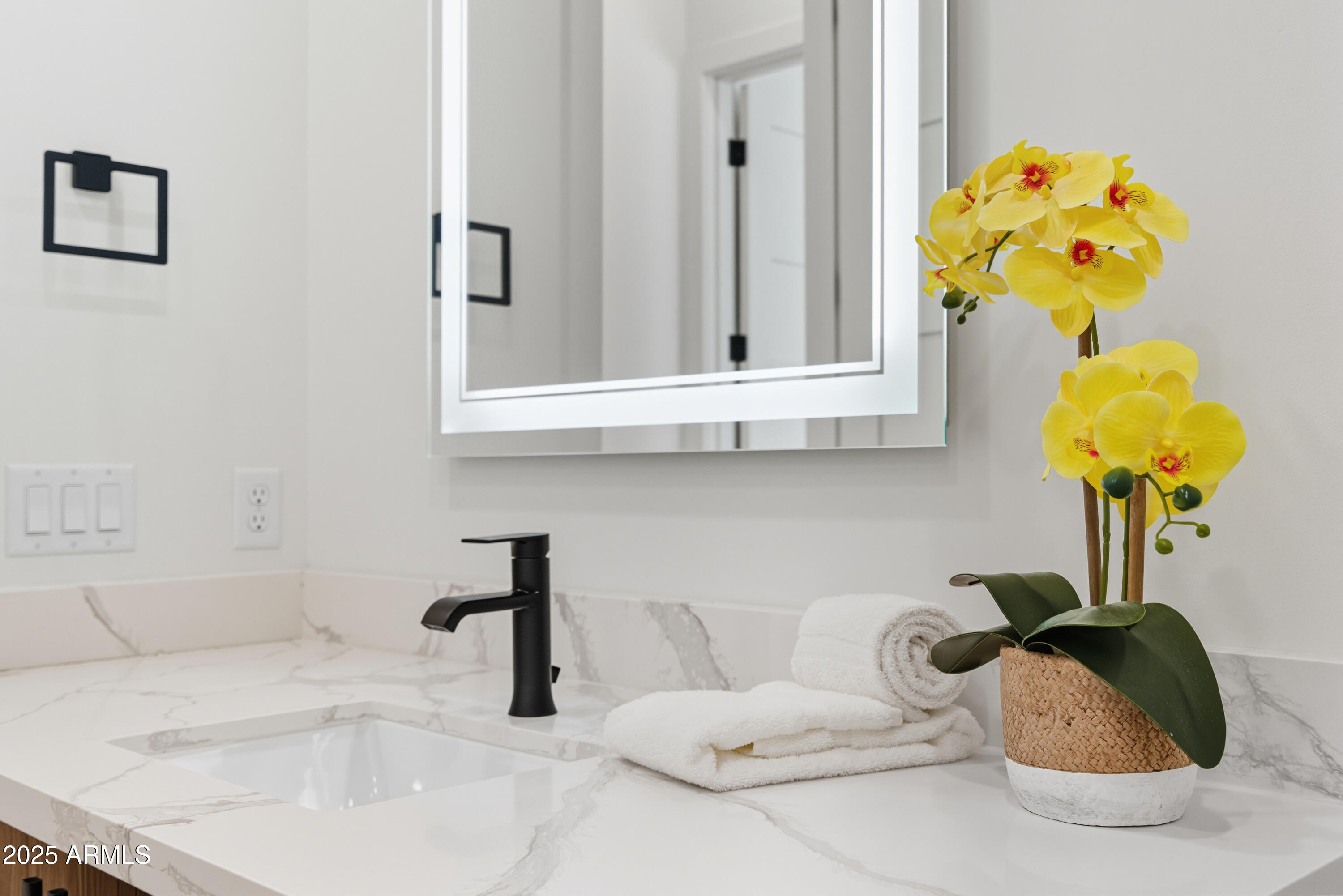 1501 North Miller Road, Unit 1015 Scottsdale, AZ 85257 - Photo 32 of 50 a bathroom with a sink mirror and flowers
