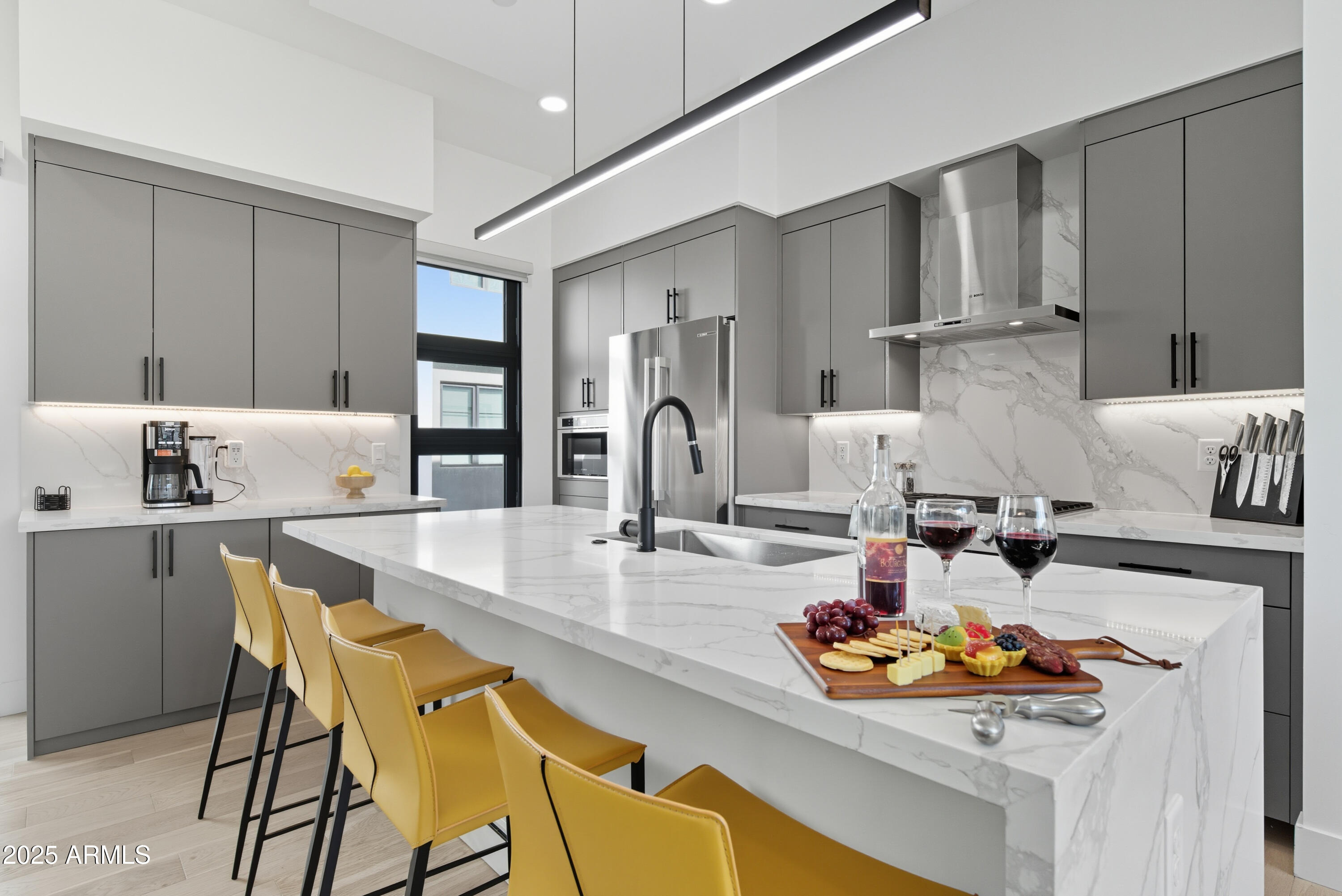 1501 North Miller Road, Unit 1015 Scottsdale, AZ 85257 - Photo 4 of 50 a kitchen with stainless steel appliances kitchen island granite countertop a table and chairs