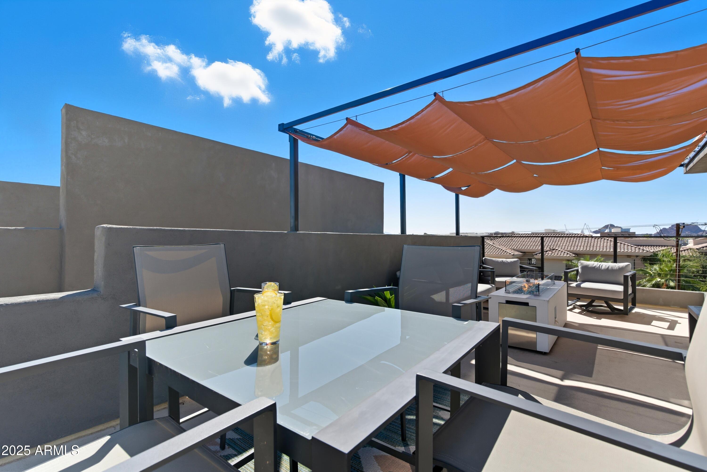1501 North Miller Road, Unit 1015 Scottsdale, AZ 85257 - Photo 42 of 50 a view of a dining room with furniture and a chandelier