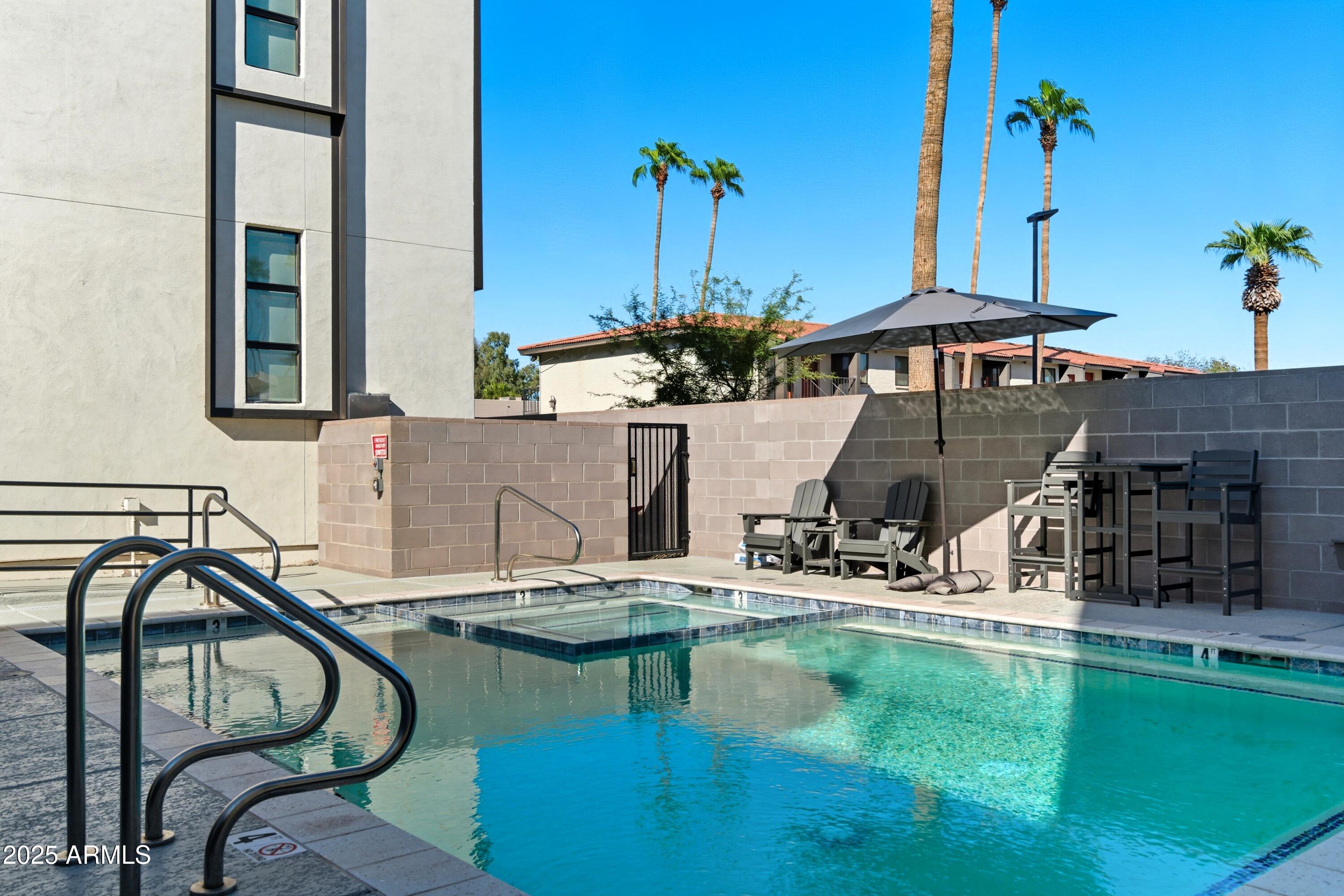 1501 North Miller Road, Unit 1015 Scottsdale, AZ 85257 - Photo 49 of 50 a house view with a seating space and a swimming pool