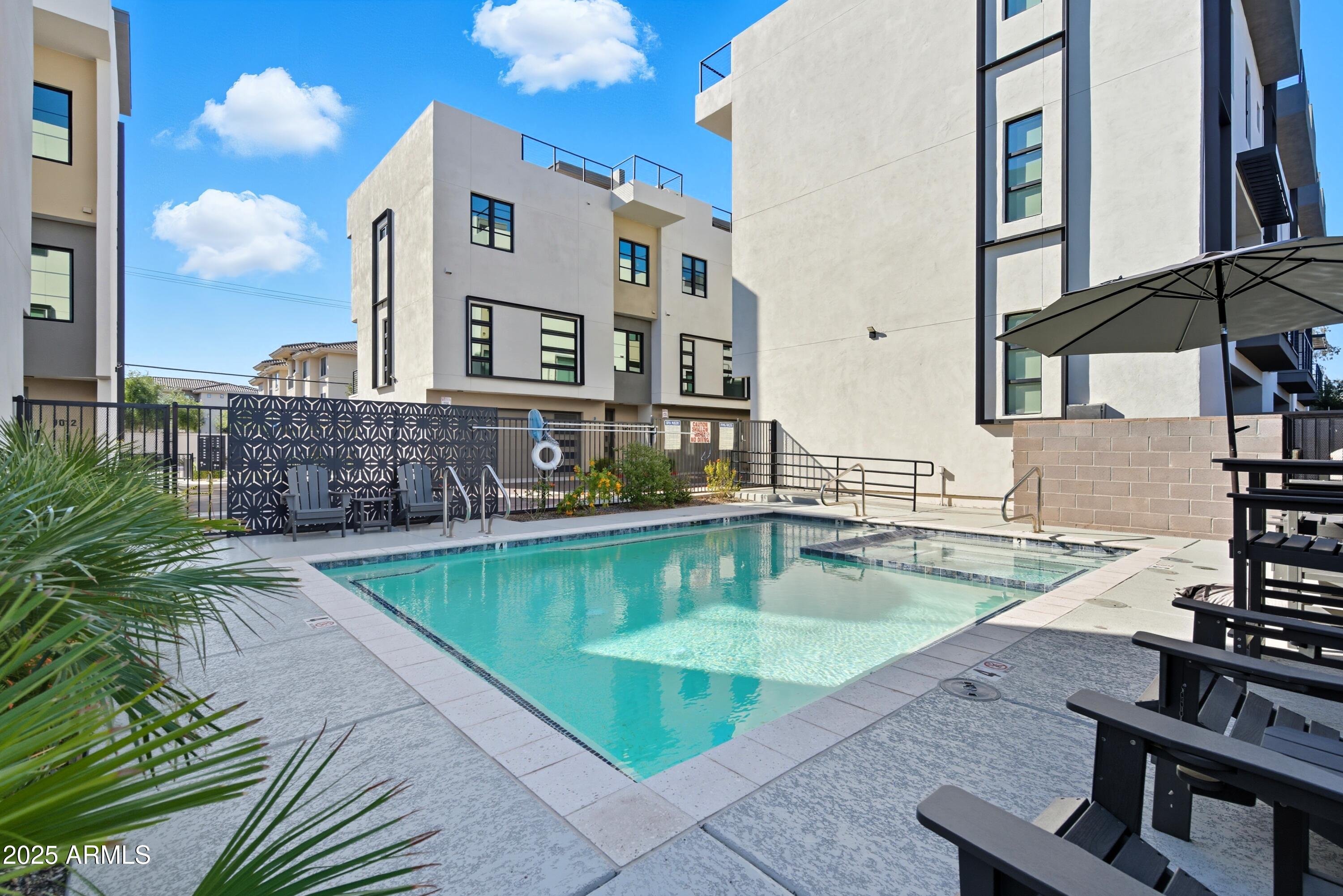 1501 North Miller Road, Unit 1015 Scottsdale, AZ 85257 - Photo 50 of 50 a view of a swimming pool with a lounge chairs