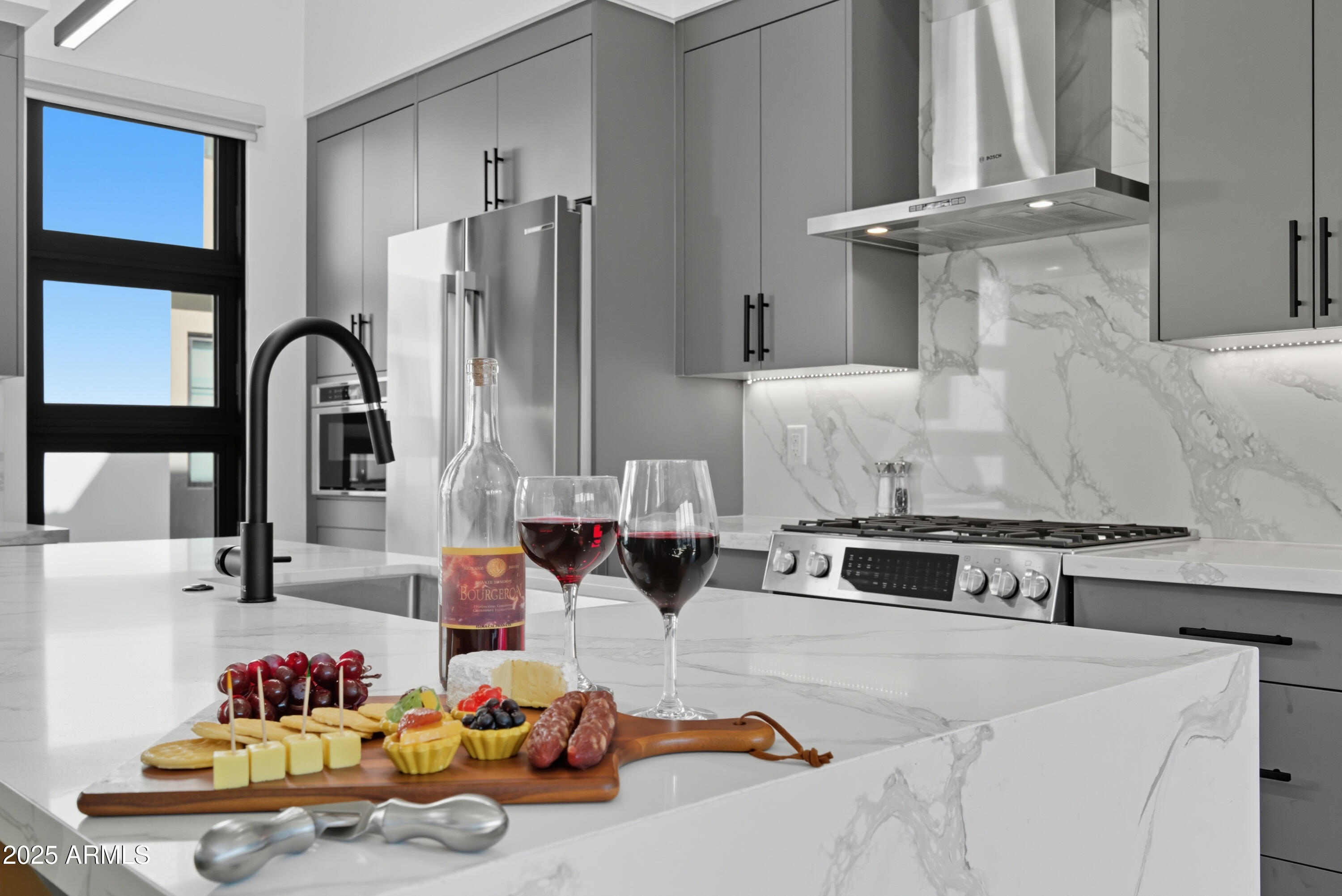 1501 North Miller Road, Unit 1015 Scottsdale, AZ 85257 - Photo 5 of 50 a kitchen with stainless steel appliances granite countertop a sink and a stove