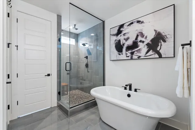 a white bath tub sitting next to a white wall