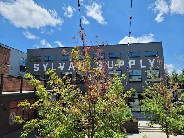 a view of a patio with table and chairs potted plants