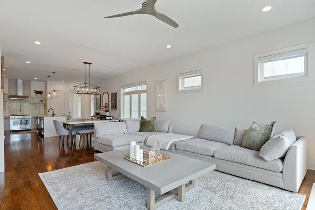a living room with furniture and a dining table