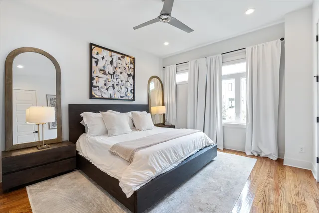 a bedroom with a bed and a painting on the wall