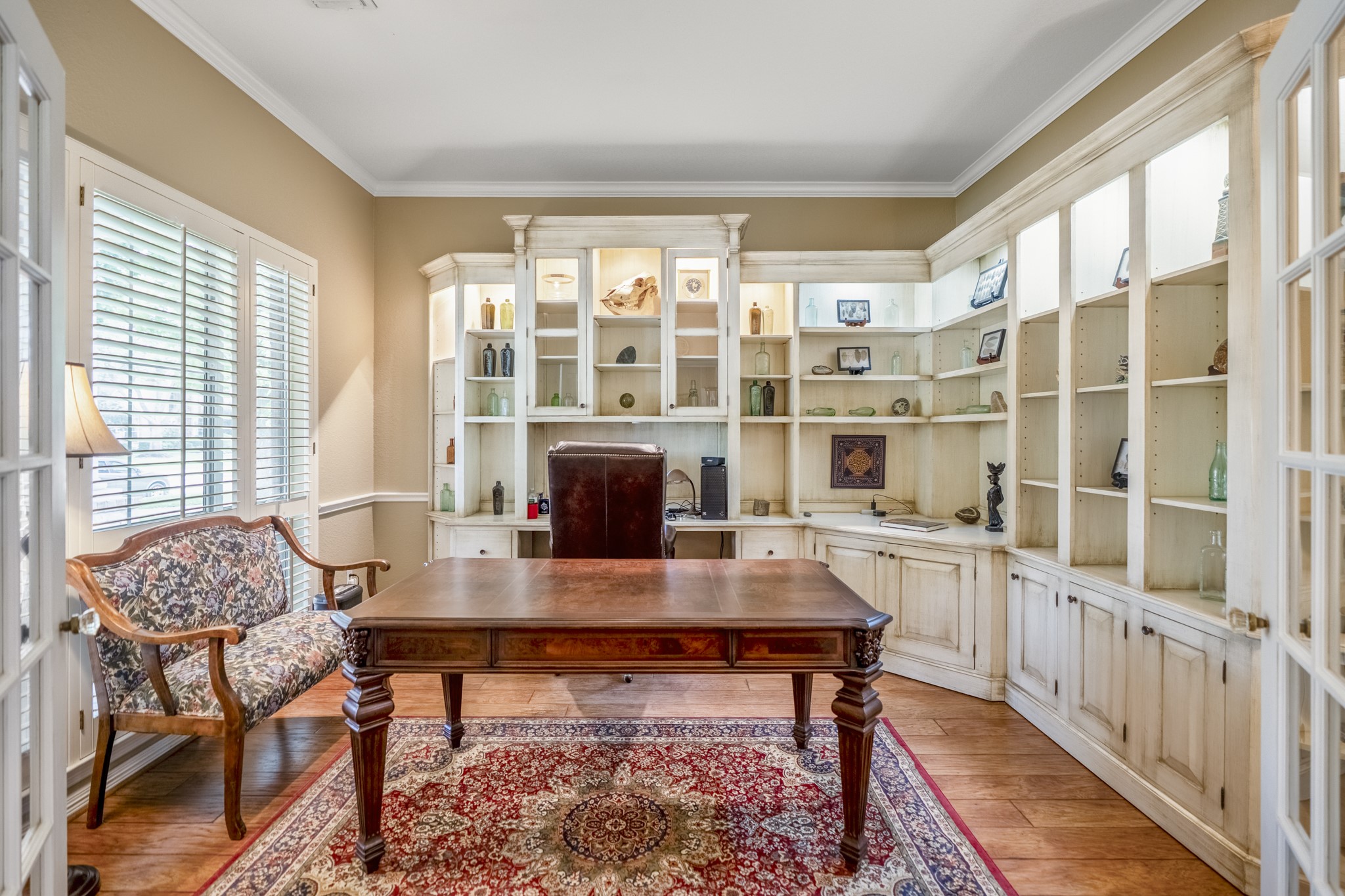 1438 Hatchmere Place Spring, TX 77379 - Photo 8 of 50 French doors open into the large study which offers gleaming wood floors, large windows with plantation shutters and tons of custom built-ins.