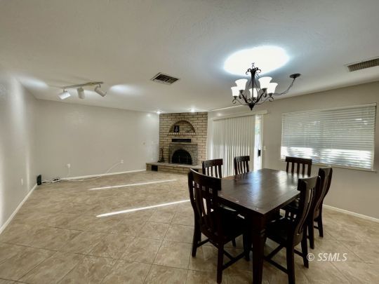 521 Scott Street Ridgecrest, CA 93555 - Photo 8 of 33 a view of a dining room with furniture and chandelier