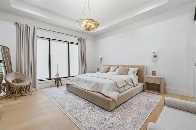 a bedroom with a bed and a chandelier