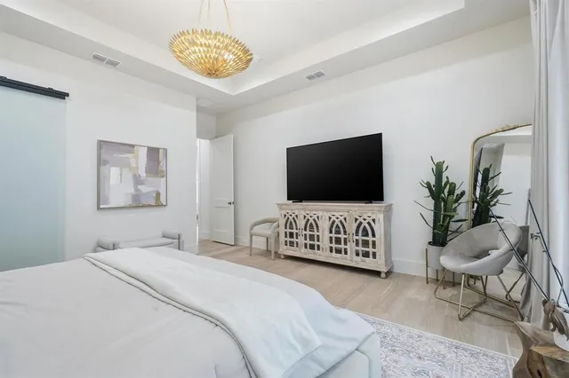 a bedroom with bed and a flat screen tv