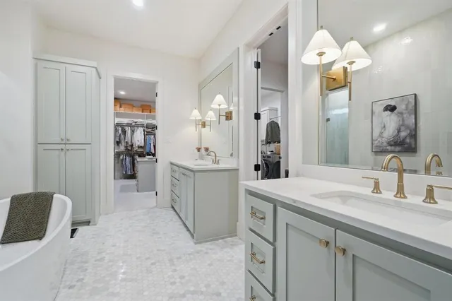 a bathroom with a sink a faucet a mirror and a shower