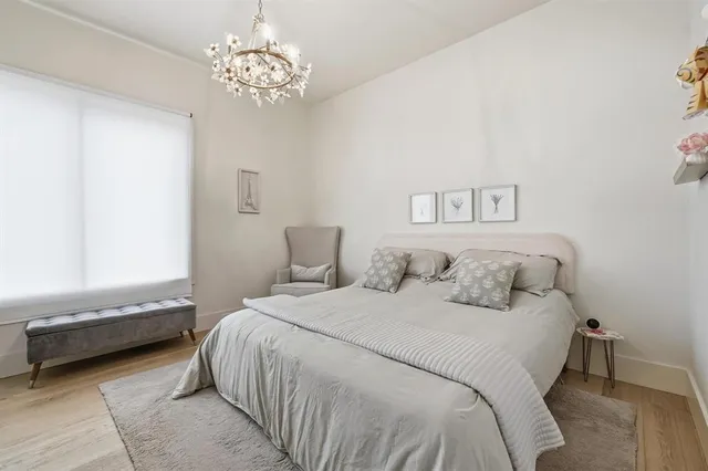 a bedroom with a bed and a chandelier