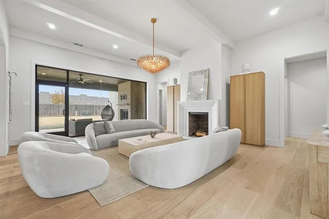 a living room with fireplace furniture and a chandelier