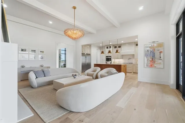 a living room with furniture and a chandelier
