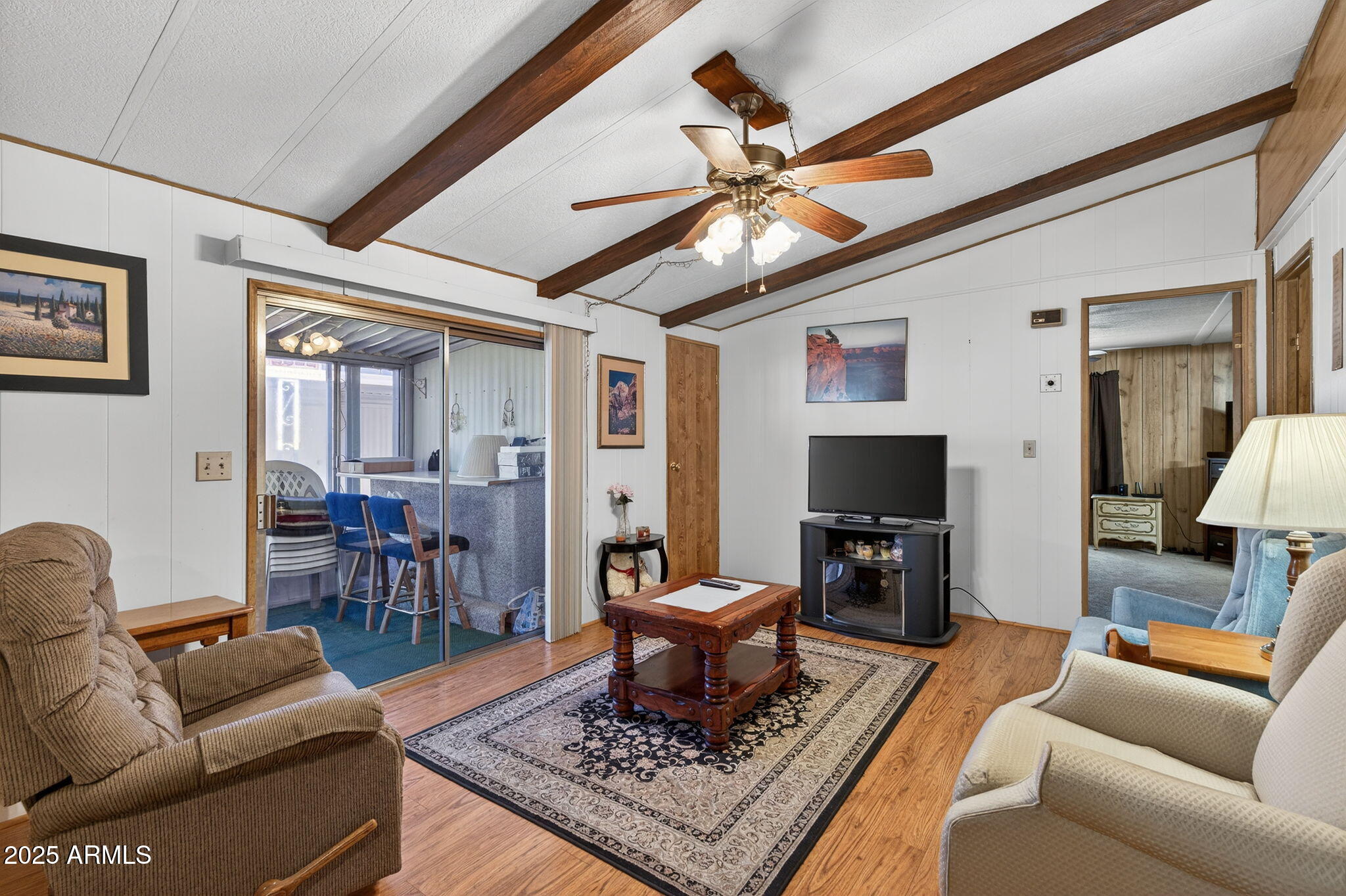 2100 North Trekell Road, Unit 131 Casa Grande, AZ 85122 - Photo 13 of 46 a living room with furniture a flat screen tv and a chandelier