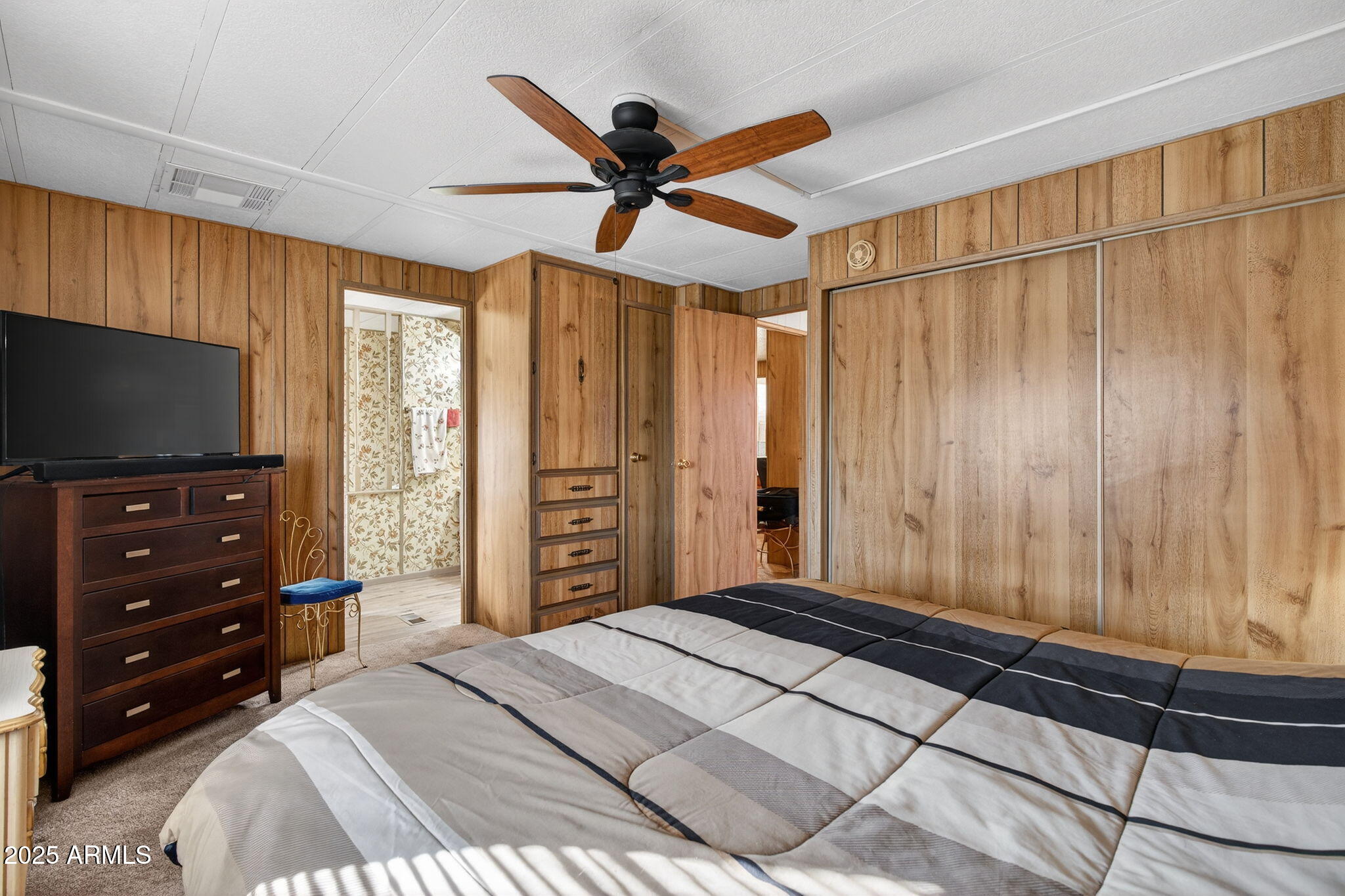 2100 North Trekell Road, Unit 131 Casa Grande, AZ 85122 - Photo 17 of 46 a bedroom with a bed and a flat screen tv