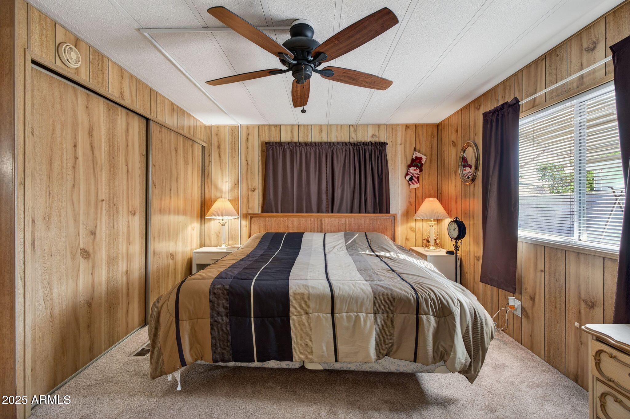 2100 North Trekell Road, Unit 131 Casa Grande, AZ 85122 - Photo 18 of 46 a bed sitting in a bedroom next to a window