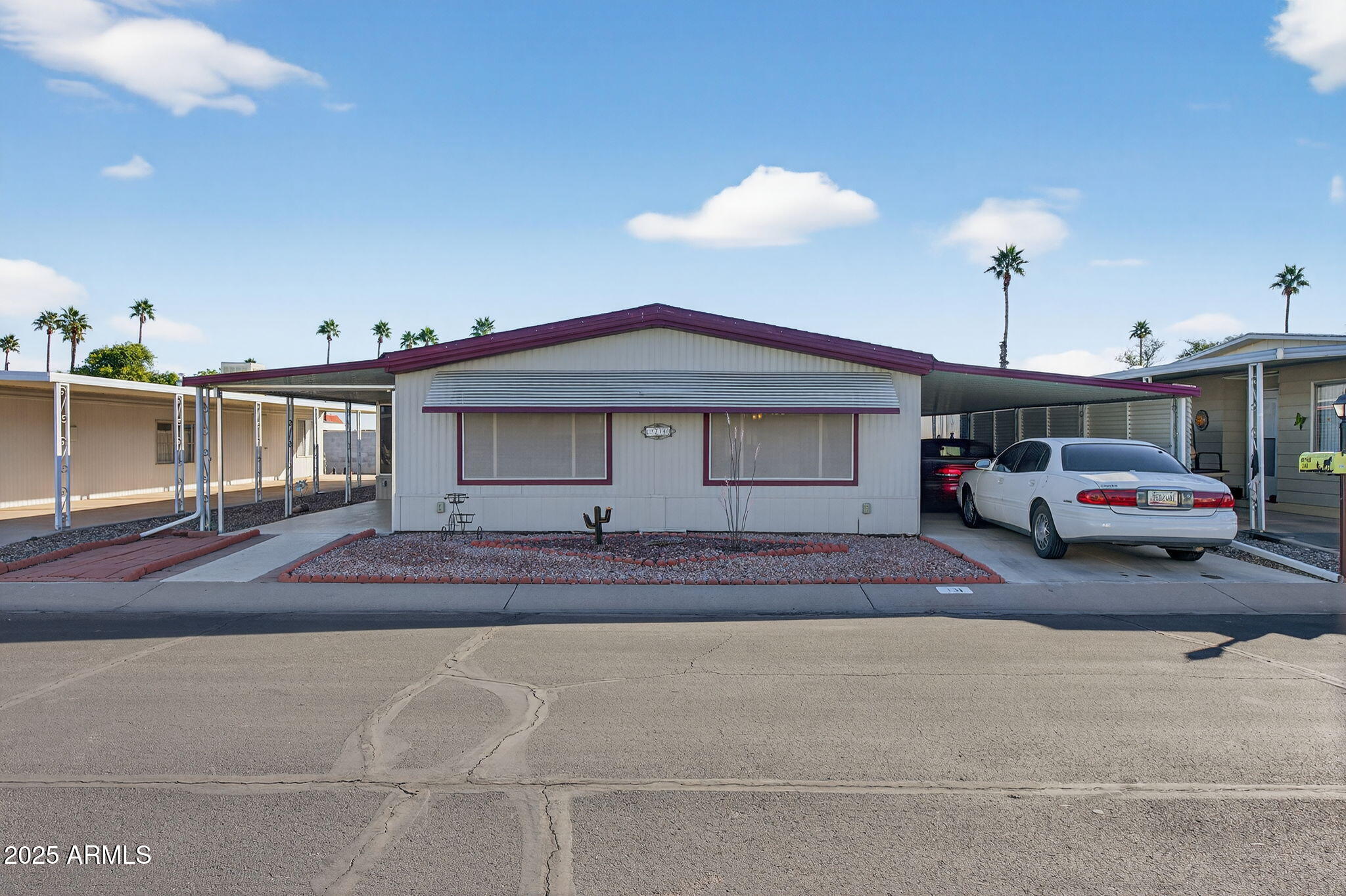 2100 North Trekell Road, Unit 131 Casa Grande, AZ 85122 - Photo 2 of 46 a front view of a house with a garden and parking