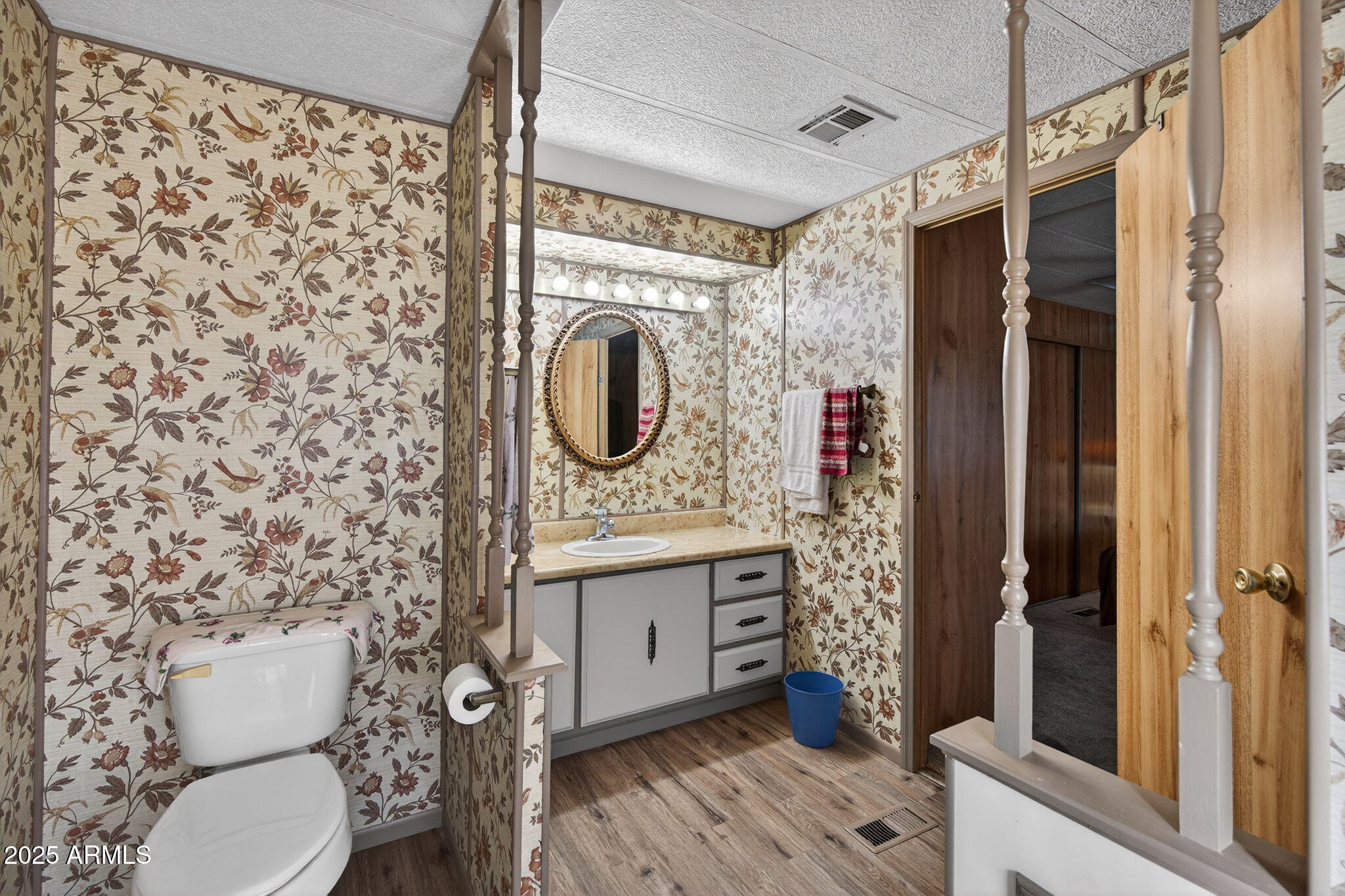 2100 North Trekell Road, Unit 131 Casa Grande, AZ 85122 - Photo 21 of 46 a bathroom with a toilet a sink and a mirror