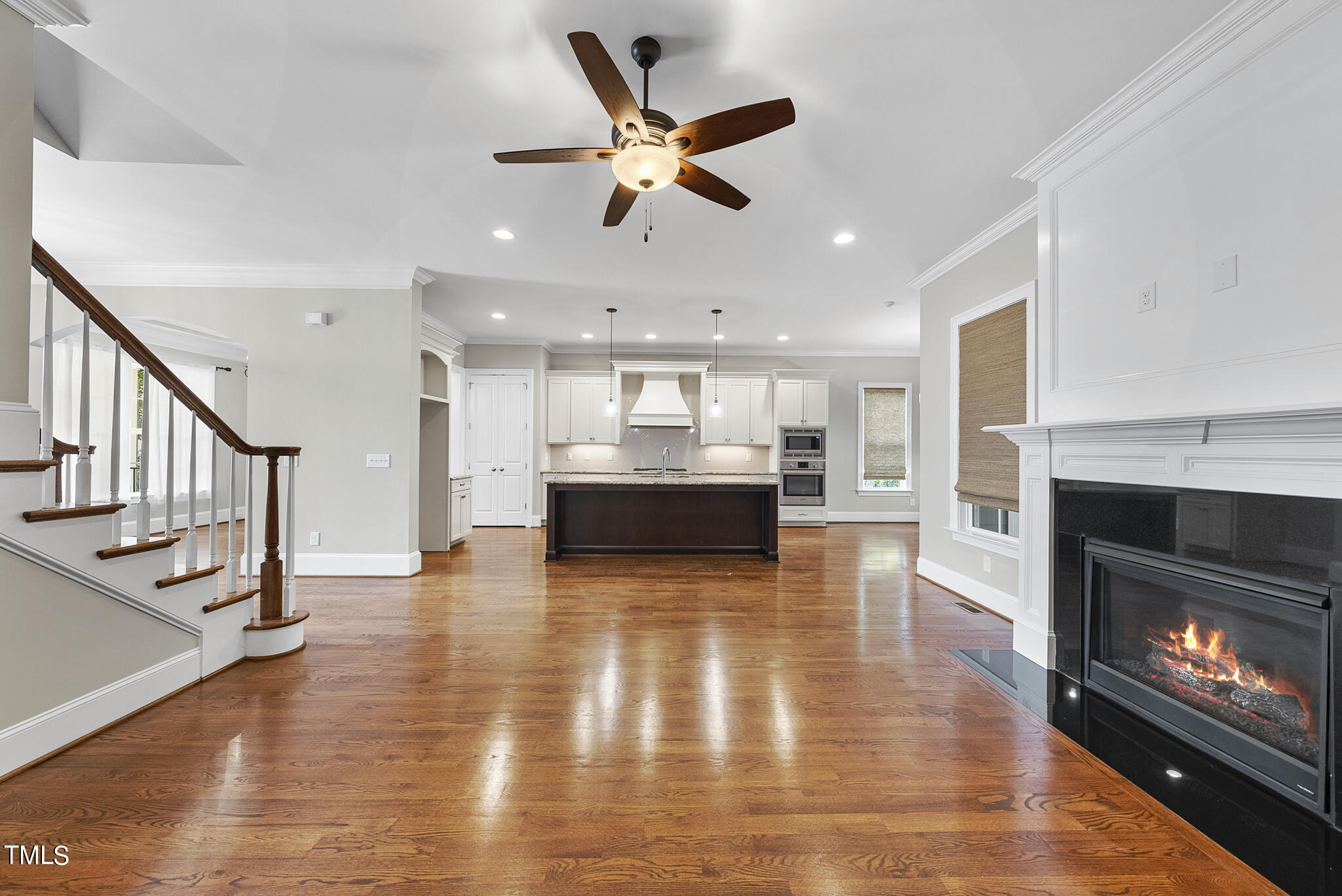 6411 Rosny Road Raleigh, NC 27613 - Photo 11 of 30 a view of an empty room with kitchen and fireplace