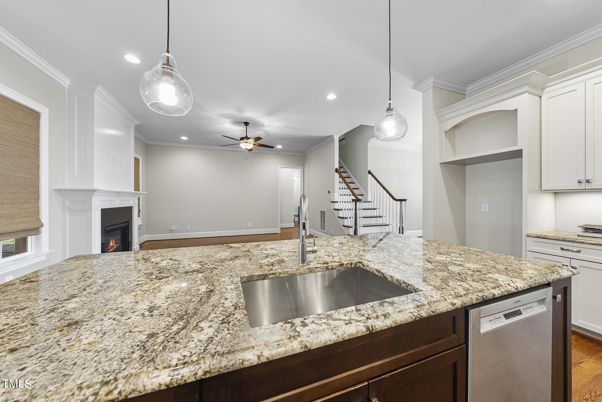 6411 Rosny Road Raleigh, NC 27613 - Photo 17 of 30 a kitchen with kitchen island a sink stainless steel appliances and a counter top space