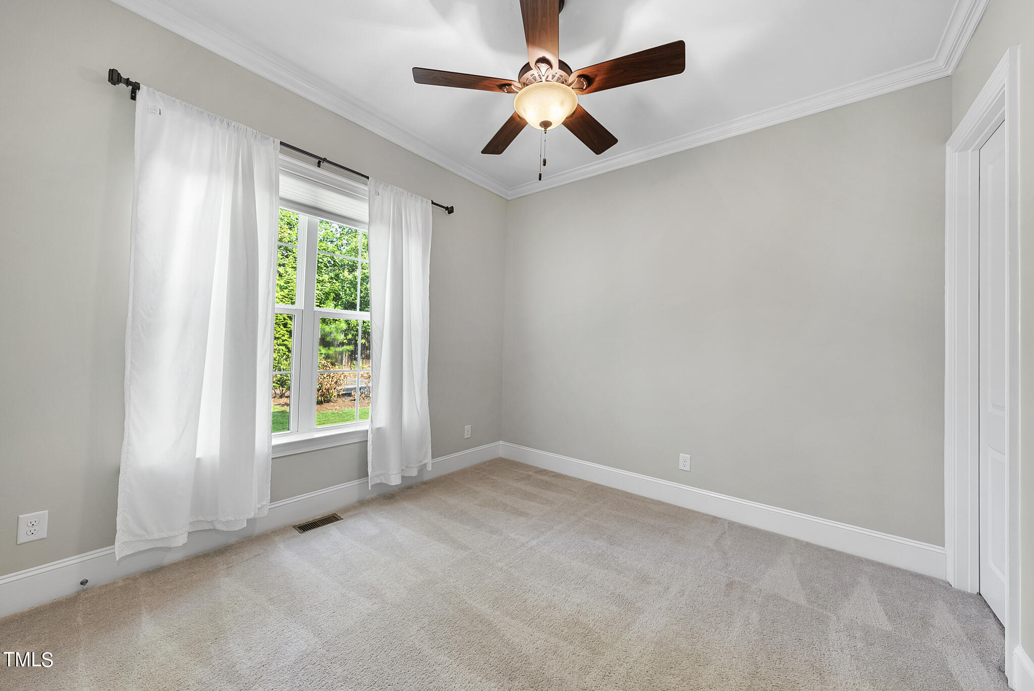 6411 Rosny Road Raleigh, NC 27613 - Photo 19 of 30 an empty room with a window and a fan