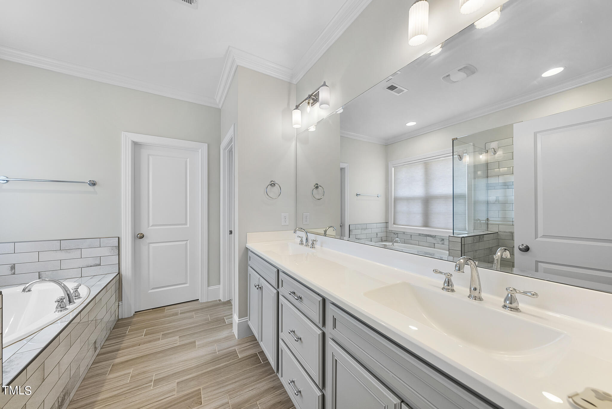 6411 Rosny Road Raleigh, NC 27613 - Photo 24 of 30 a spacious bathroom with a double vanity sink mirror and double