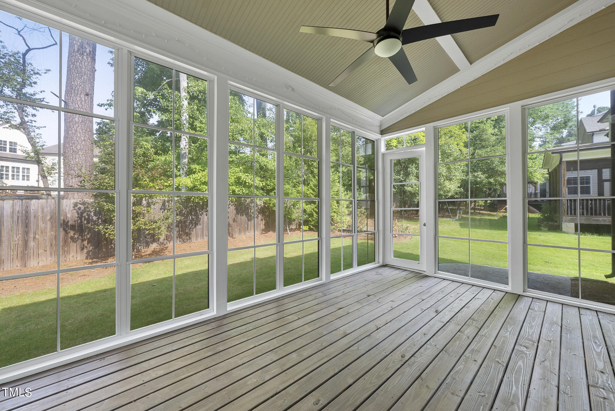 6411 Rosny Road Raleigh, NC 27613 - Photo 10 of 30 a view of porch with wooden floor and floor to ceiling windows